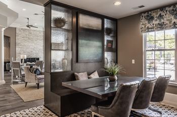 A dining room with a table and chairs